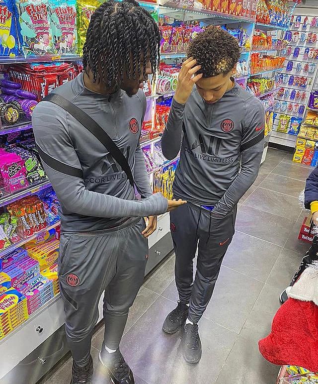 young people wearing psg football tracksuits